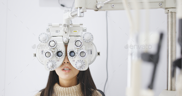 Asian Woman doing eye test in clinic - Stock Photo - Images
