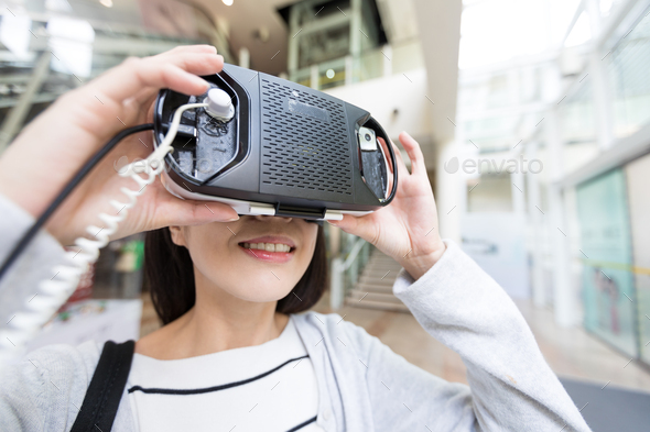 Woman try on virtual reality in shopping mall