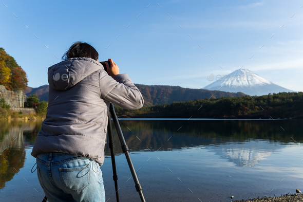 Woman take photo by camera on Mount Fuji - Stock Photo - Images