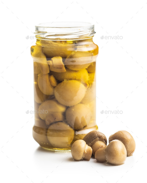 Pickled champignons. Marinated mushrooms in jar - Stock Photo - Images