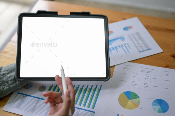 Experts are using a tablet to check the company earnings. - Stock Photo - Images