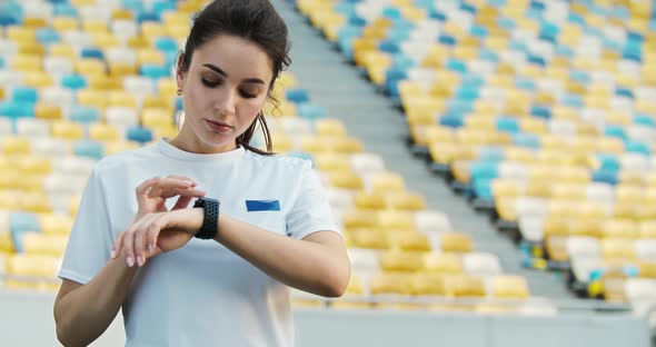 Female Jogger Setting Smartwatch