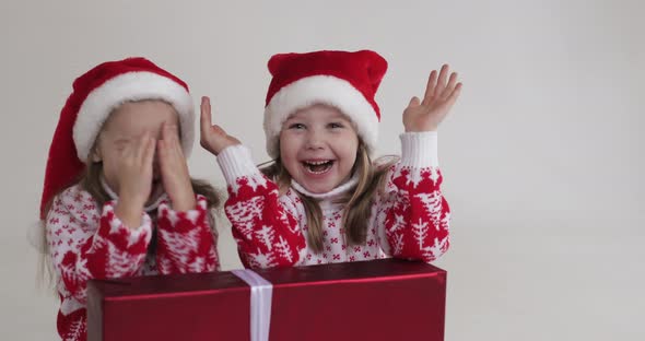 Girls in Santa Hats Hiding and Opening Eyes.