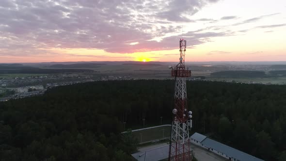 Aerial view of Mobile Communication Tower in forest in village at sunset 11 alt