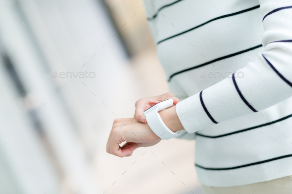 Woman use of smart watch at indoor - Stock Photo - Images