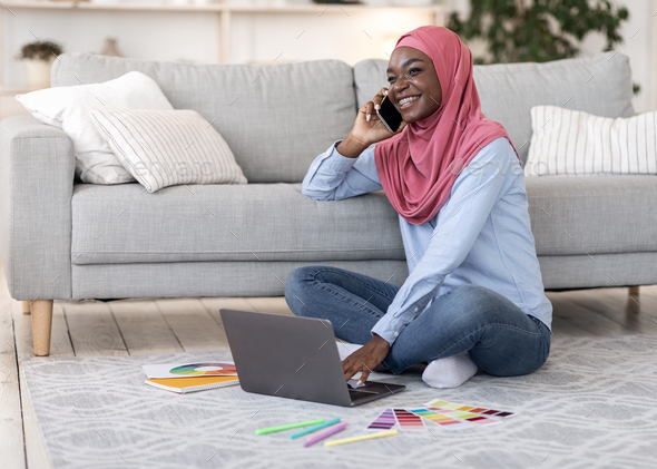Remote Work For Muslim Women. Black Lady Using Cellphone And Laptop At Home