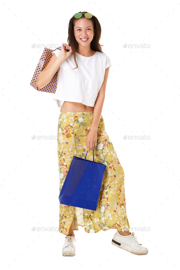 Full length stylish young asian woman posing with shopping bags against isolated white background - Stock Photo - Images