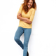 Full body happy young woman with curly hair against white wall Stock Photo  by mimagephotography