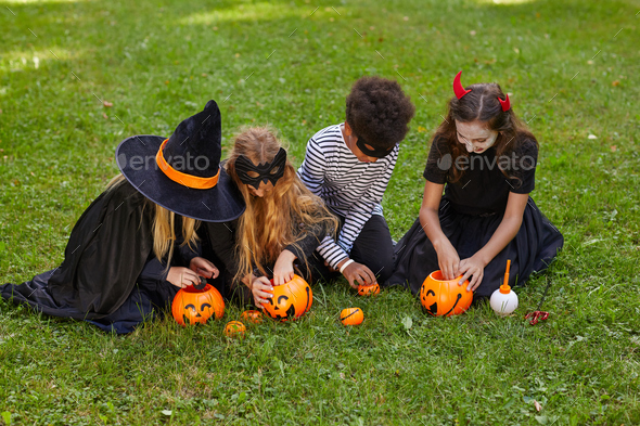 Group of Kids Playing Outdoors on Halloween Stock Photo by ...