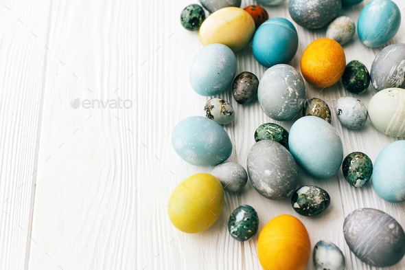 Modern easter eggs painted with natural dye in yellow, blue, green, grey colors - Stock Photo - Images