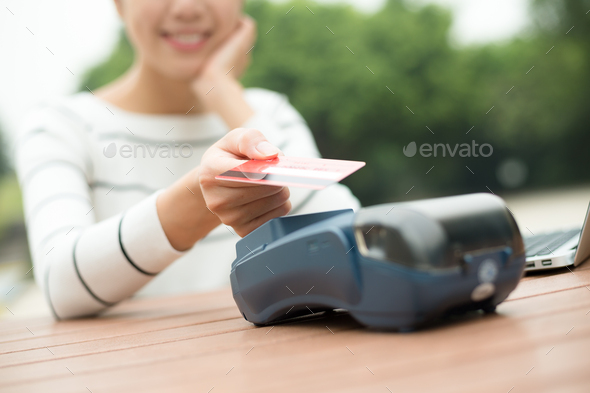 Woman pay by mobile phone on pos machine - Stock Photo - Images
