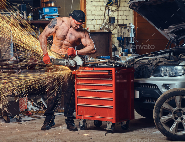 A man in a garage. - Stock Photo - Images