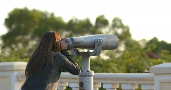 Travel woman look tough the binocular at outdoor alt