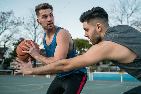 Young basketball players playing one-on-one. - Stock Photo - Images