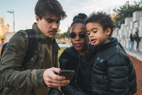 Mixed race ethnic family at park. - Stock Photo - Images