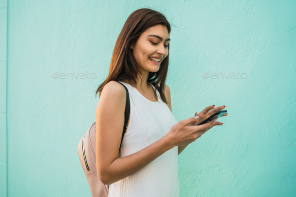 Young woman using her mobile phone. - Stock Photo - Images