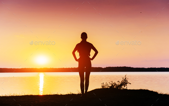 girl at sunset by the lake - Stock Photo - Images