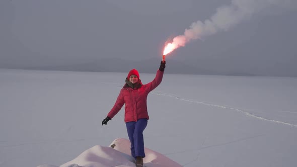 A Woman in a Winter Ski Suit with a Signal Checker in Her Hand in Winter