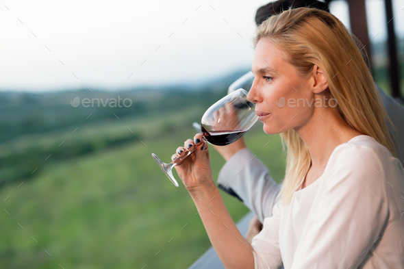 Woman tasting wine in wine grower vineyard