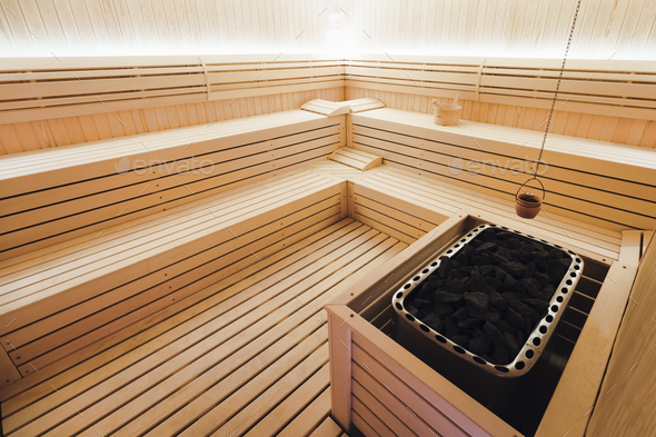 Beautiful sauna interior with heater and stones