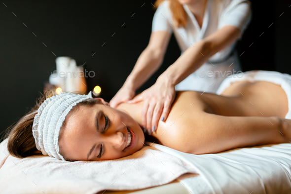 Massage therapist massaging woman - Stock Photo - Images