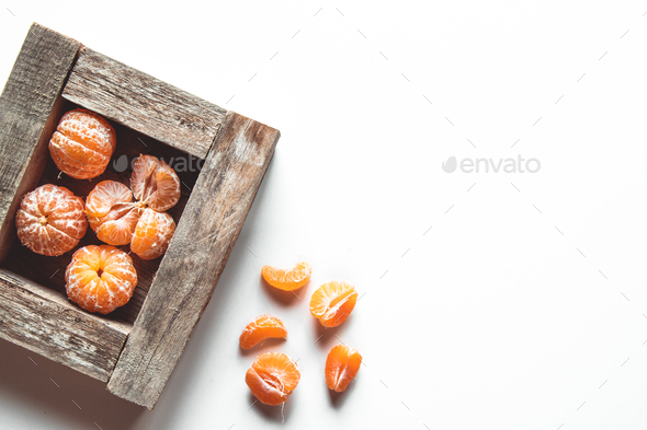 tangerines with fresh leaves in wooden box isolated on white, isolated on a white, top view - Stock Photo - Images