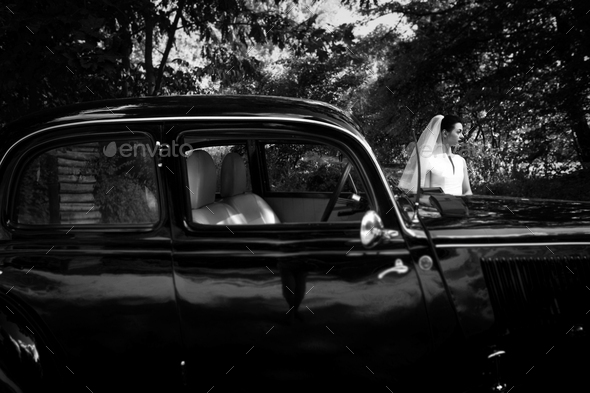 Gorgeous bride on background of stylish black car - Stock Photo - Images