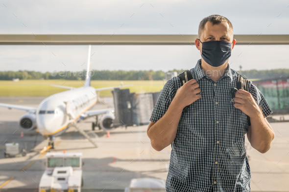 Man with a backpack waiting for departure in Covid19 time - Stock Photo - Images