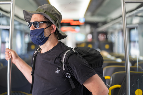 Man with a mask talking traveling in the train during Covid19 pandemic - Stock Photo - Images