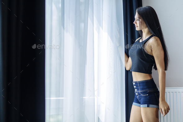 Happy beautiful woman staring out the window - Stock Photo - Images