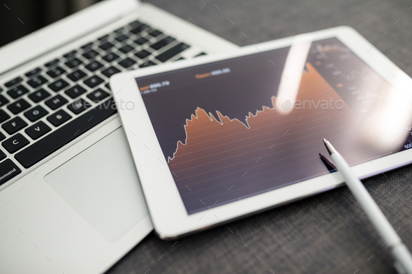 Analyzing stock market from a digital tablet - Stock Photo - Images
