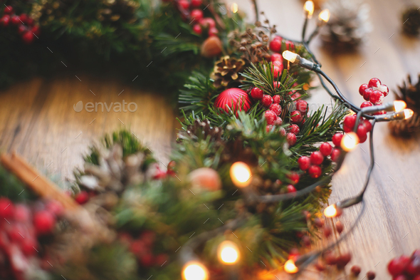 Christmas wreath decorations close up on rustic wood in lights. - Stock Photo - Images