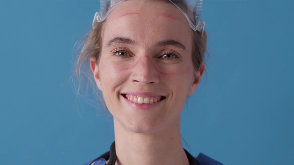 Close portrait of tired doctor during pandemic covid-19, takes off glasses, protective mask