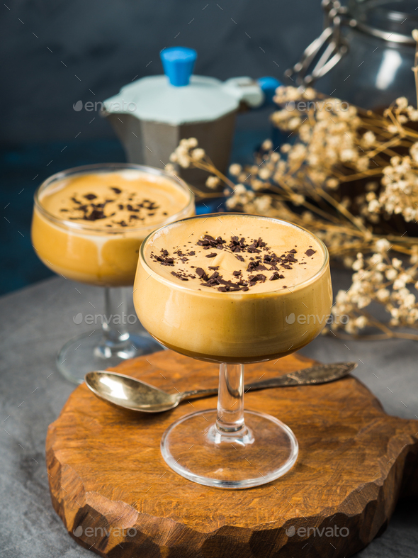 Frappe coffee in dessert glasses on brown backdrop - Stock Photo - Images