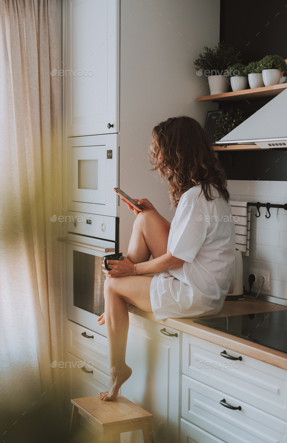Young pretty woman drinks coffee - Stock Photo - Images