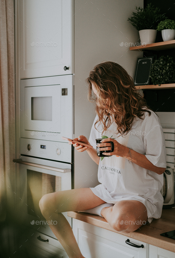 Young pretty woman drinks coffee - Stock Photo - Images