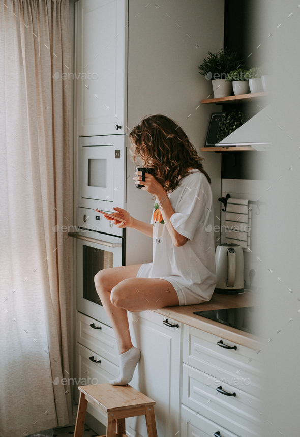 Young pretty woman drinks coffee - Stock Photo - Images