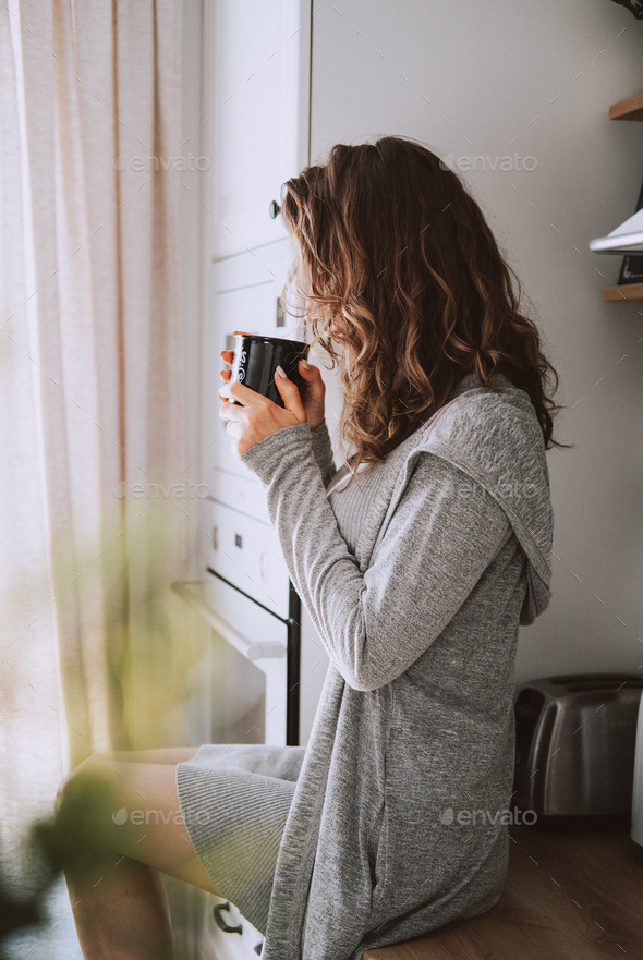 Young pretty woman drinks coffee - Stock Photo - Images
