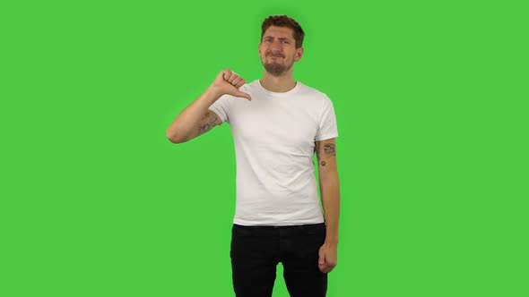 Confident Guy Is Showing Thumbs Down Gesture. Green Screen alt
