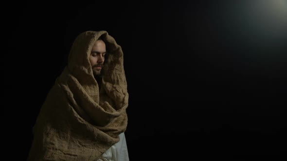 Man in Robe Coming Out of Darkness and Looking to Camera, Biblical Messiah, God alt