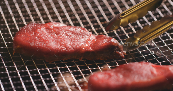 BBQ Steak on metal net - Stock Photo - Images