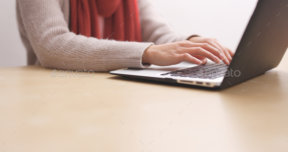 Woman typing on notebook computer - Stock Photo - Images