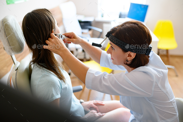 Female ent doctor and patient in office, ear exam