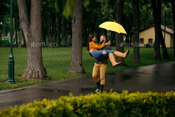 Happy love couple relaxing in summer rainy day - Stock Photo - Images