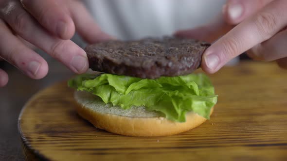Chef Cooks Burger and Puts Cutlet To the Leafs of Fresh Green Salad, Fast Food Restaurant, UHD 60p