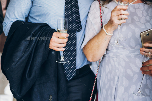 hands of stylish people cheering with glasses of champagne - Stock Photo - Images