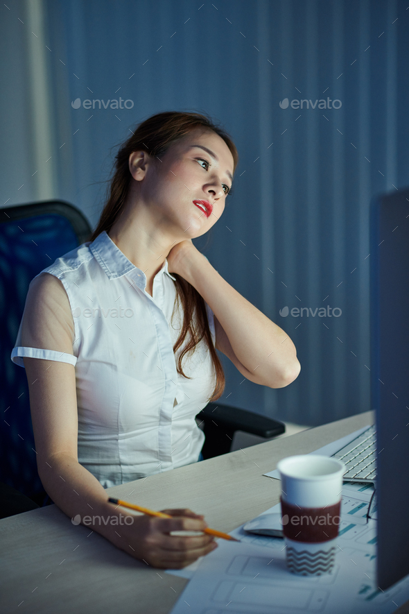 Project manager rubbing stiff neck - Stock Photo - Images