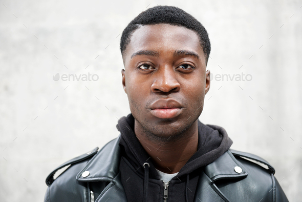 Close up portrait of young black man staring