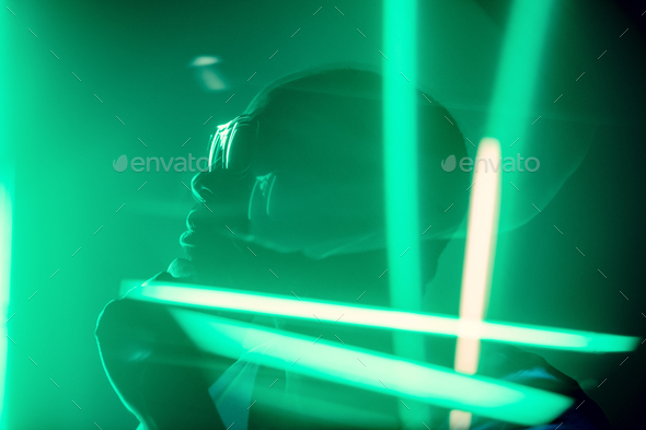 Cinematic portrait of handsome young man in neon lighted room, stylish musician - Stock Photo - Images