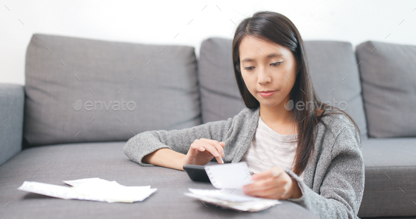 Housewife counting the expense at home - Stock Photo - Images